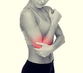 Image showing sporty woman with pain in elbow