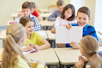 Image showing group of school kids writing test in classroom