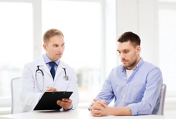 Image showing doctor with clipboard and patient in hospital