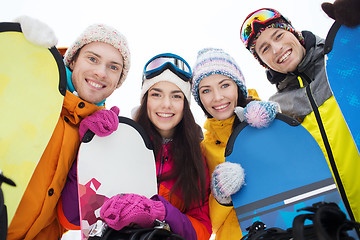 Image showing happy friends with snowboards