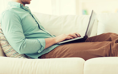 Image showing close up of man working with laptop at home