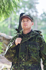 Image showing young soldier or hunter with gun in forest