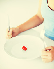 Image showing woman with plate and one tomato