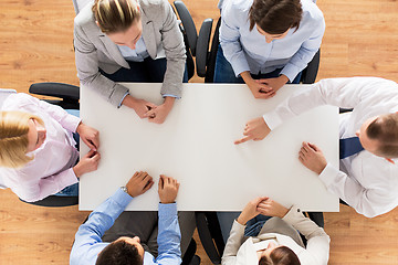 Image showing close up of business team sitting at table