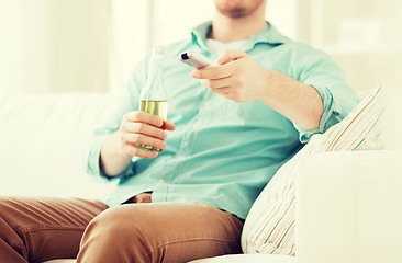 Image showing man with beer and remote control at home
