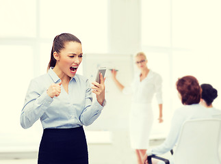 Image showing screaming businesswoman with smartphone