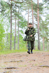 Image showing young soldier or hunter with gun in forest