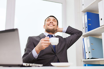 Image showing businessman with laptop typing in office