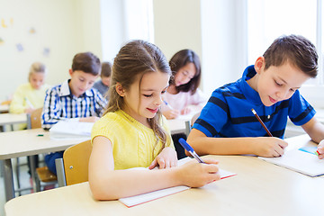 Image showing group of school kids writing test in classroom