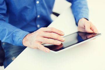 Image showing close up of male hands working with tablet pc