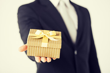 Image showing man hands holding gift box