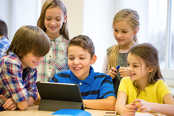 Image showing group of school kids with tablet pc in classroom