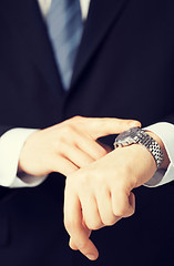 Image showing man looking at wristwatch