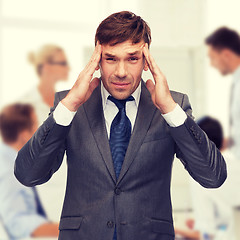 Image showing stressed buisnessman or teacher having headache