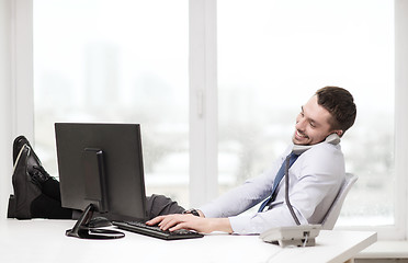 Image showing smiling businessman or student with computer