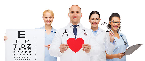 Image showing group of smiling doctors with red heart shape