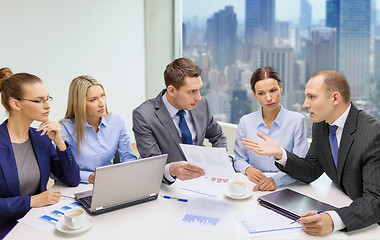 Image showing business team with laptop and papers meeting