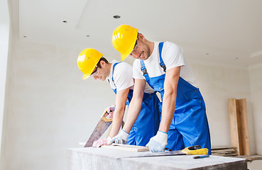 Image showing group of builders with tools indoors