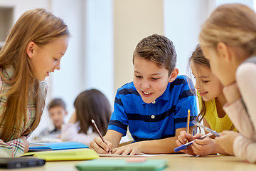 Image showing group of students talking and writing at school