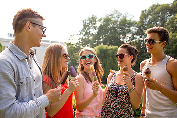 Image showing group of smiling friends with ice cream outdoors