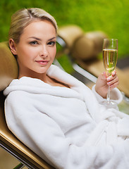 Image showing beautiful young woman drinking champagne at spa