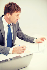 Image showing businessman with laptop computer and documents