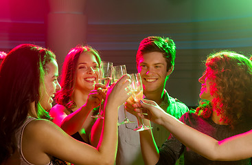 Image showing smiling friends with glasses of champagne in club