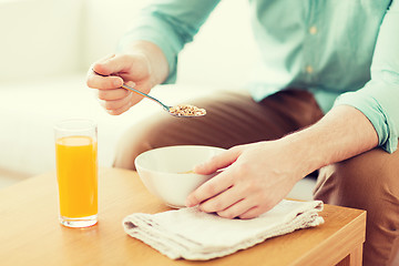 Image showing close up of man eating breakfast at home