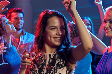 Image showing smiling friends with glasses of champagne in club