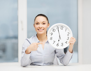 Image showing attractive businesswoman with white clock