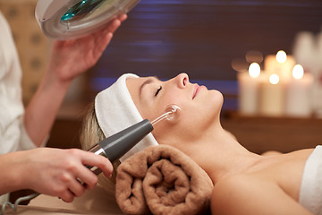 Image showing close up of young woman having face massage in spa