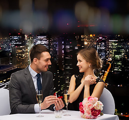 Image showing man proposing to his girlfriend at restaurant