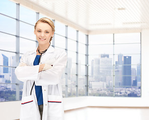 Image showing smiling young female doctor in white coat