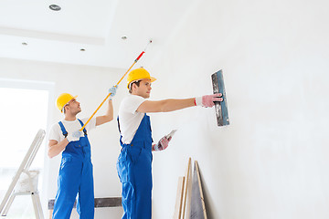 Image showing group of builders with tools indoors