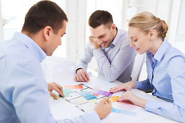 Image showing smiling interior designers working in office