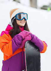 Image showing happy young woman with snowboard outdoors