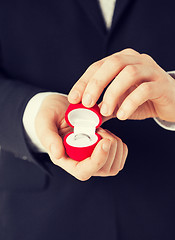 Image showing man with gift box and wedding ring