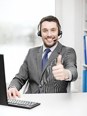 Image showing helpline operator with headphones and computer