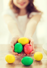 Image showing close up of girl holding colored eggs