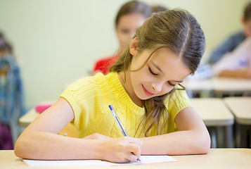 Image showing group of school kids writing test in classroom