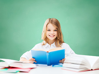 Image showing happy student girl reading book at school