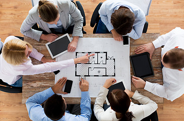 Image showing business team with blueprint and gadgets