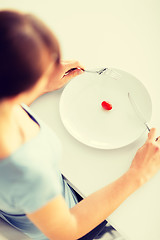 Image showing woman with plate and one tomato