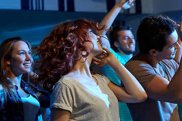 Image showing happy friends dancing at night club