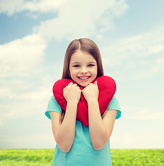 Image showing smiling little girl with red heart