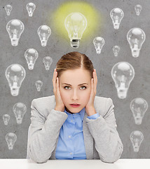 Image showing stressed woman covering her ears with hands