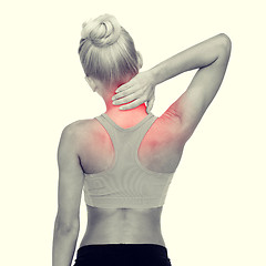 Image showing sporty woman touching her neck