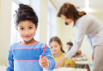 Image showing happy little school girl over classroom background