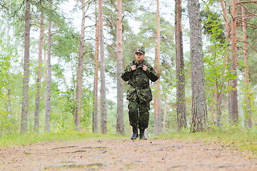 Image showing young soldier with backpack in forest