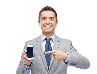 Image showing happy businessman showing smartphone screen